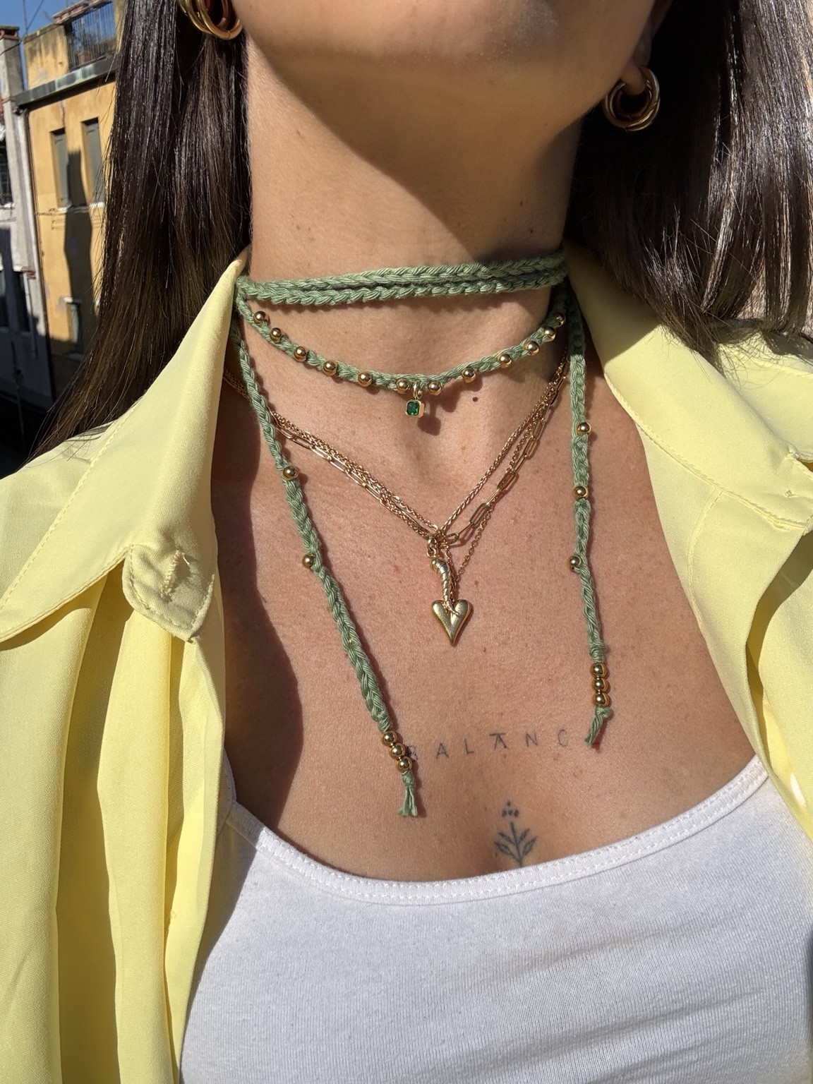 Collana crochet verde con charms dorati, indossata
